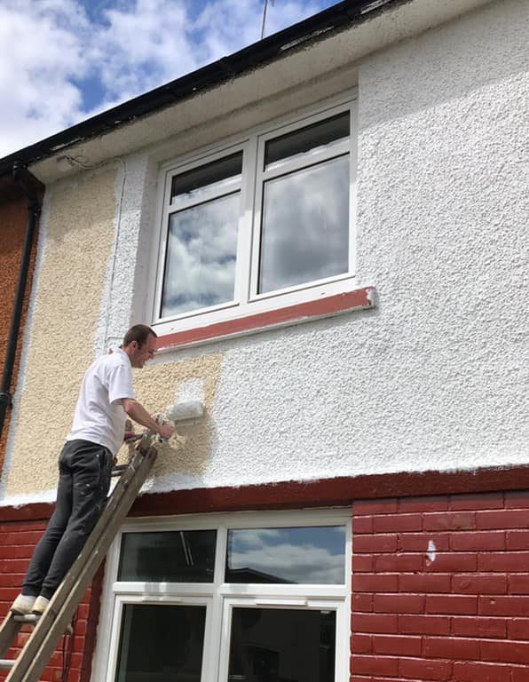 House exterior wall being painted by MacQueen Property Solutions.