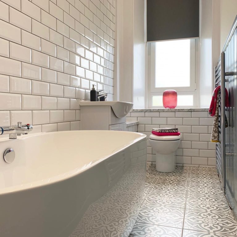 Modern tiled bathroom installed by MacQueen Property Solutions.