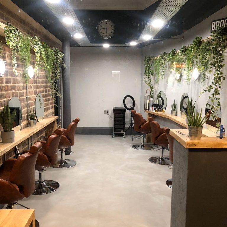 Complete renovation of a hair salon with exposed brick walls and hanging foliage by MacQueen Property Solutions.